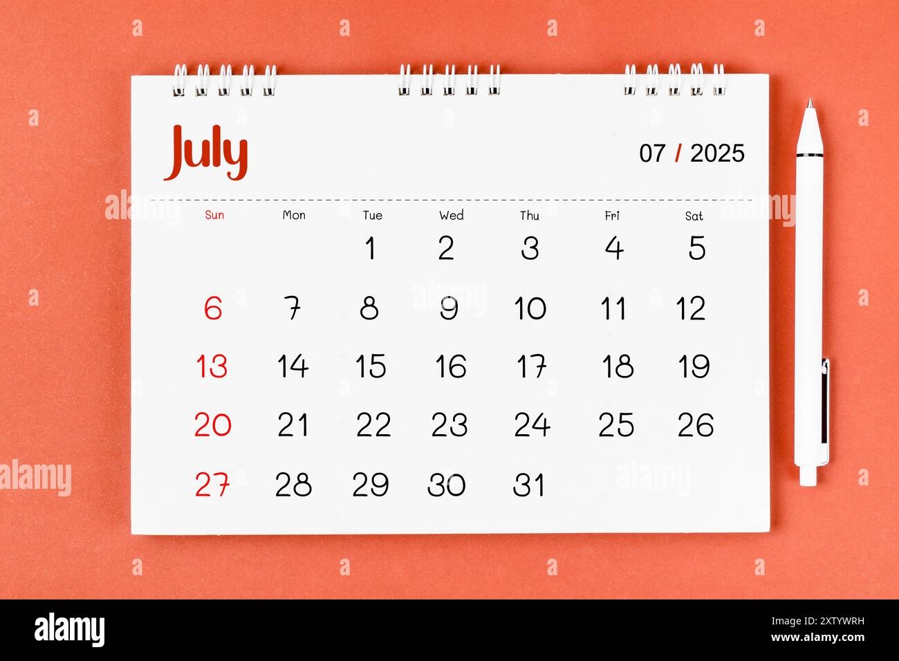 July 2025 Monthly Desk Calendar For 2025 Year And Pen On Red 
